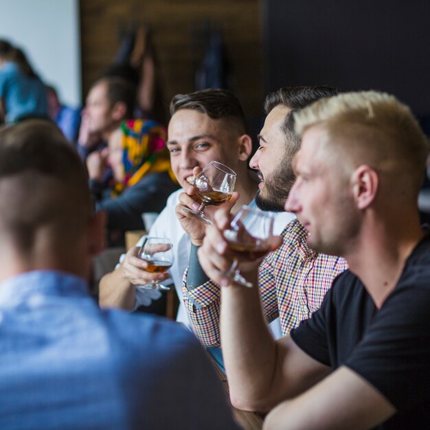 friends-sitting-restaurant-enjoying-drinks_23-2147861889